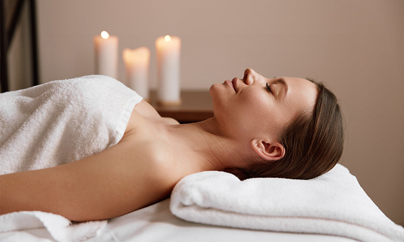 Woman experiencing low-frequency vibroacoustic resonance and full-body relaxation during immersive sound therapy session
